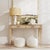 Indulge in timeless elegance with the Kai 2-drawer console table. Crafted in a serene taupe finish, its antiqued detailing...