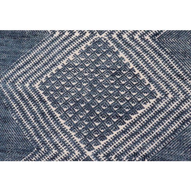 Measures 6'0 x 8'11 This elegant piece features a classic tribal stylization of vertical diamond medallions with a minimal...