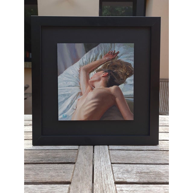 This intimate oil painting captures the serene form of a reclining figure, bathed in soft light that accentuates the...