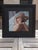 This intimate oil painting captures the serene form of a reclining figure, bathed in soft light that accentuates the...