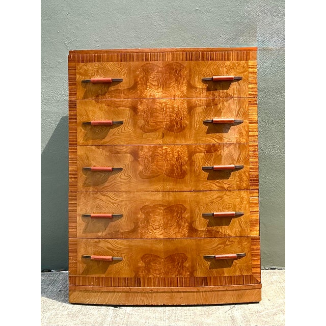 This exquisite Art Deco tallboy dresser is a masterclass in mid-century craftsmanship, featuring stunning book-matched...