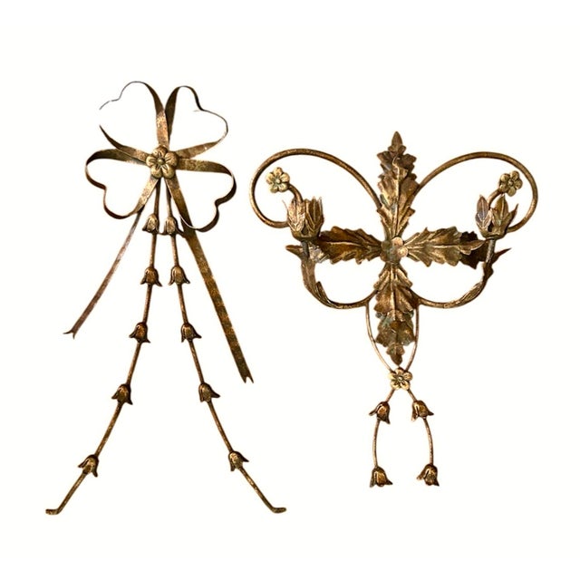 A gorgeous, vintage tole candle sconce. Features swagged bellflower chains and double flower candle cups, adorned with a...