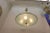 A very large pair of flying saucer chandeliers. They are made of solid brass and etched convex glass, each composed of two...