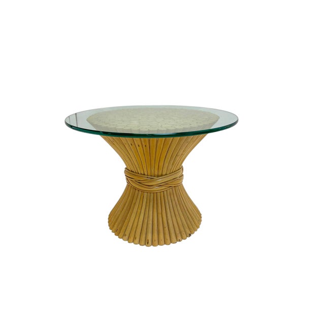 An elegant small coffee table or end table, attributed to McGuire, 1970s. The striking sculptural base is composed of...