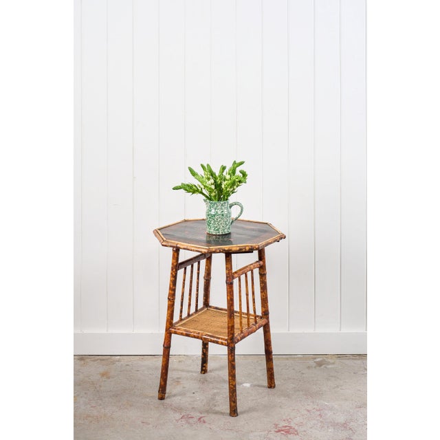 This 19th-century octagon bamboo two-tier side table features a tortoiseshell bamboo frame, an octagonal lacquered top...