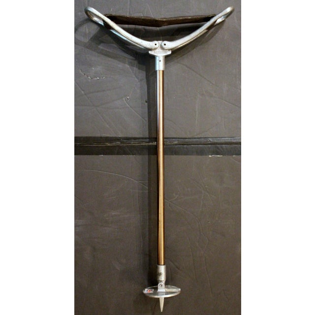 Circa 1960s English sporting event or hunting walking stick with folding seat. Steel with coppered finish shaft, leather...