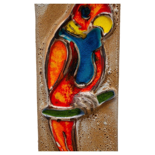 Vintage ceramic glazed wall hanging tile. Relief design of a parrot in colorful glazes and high gloss. Hangs from an iron...