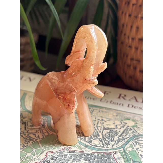 Vintage hand-carved, pink quartz elephant figurine with raised trunk. Has gorgeous translucent colorations. Please see...