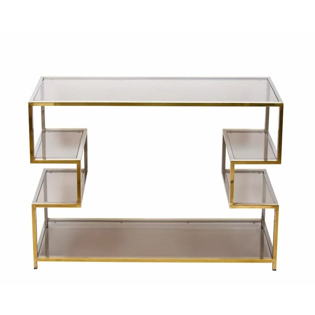 Amazing mid-century gold brass and glass console table. This marvellous piece was designed in Italy during the 1970s. This...