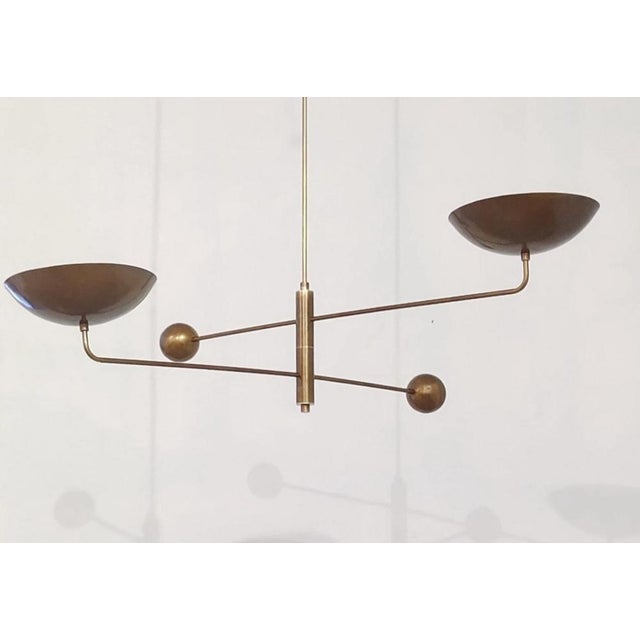 Elegant vintage brass chandelier with a geometric and minimalist design, perfect for modern, industrial, or mid-century...