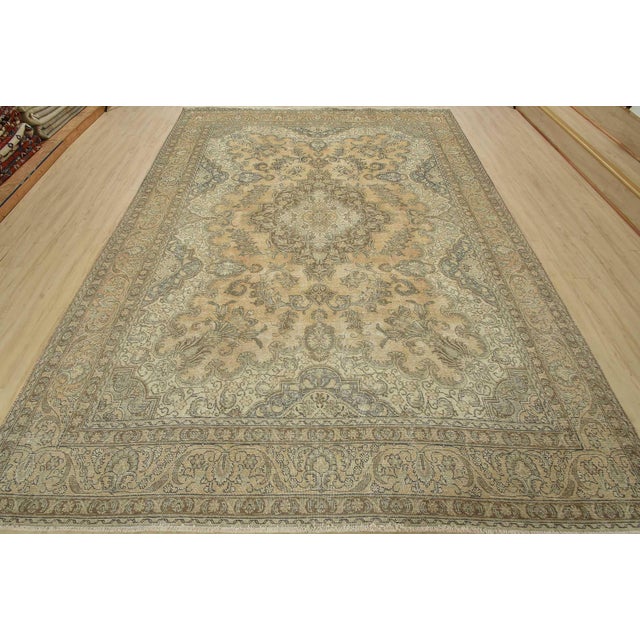 An authentic vintage traditional Tabriz rug hand-knotted with fine wool and natural dyes. This oriental rug features a...