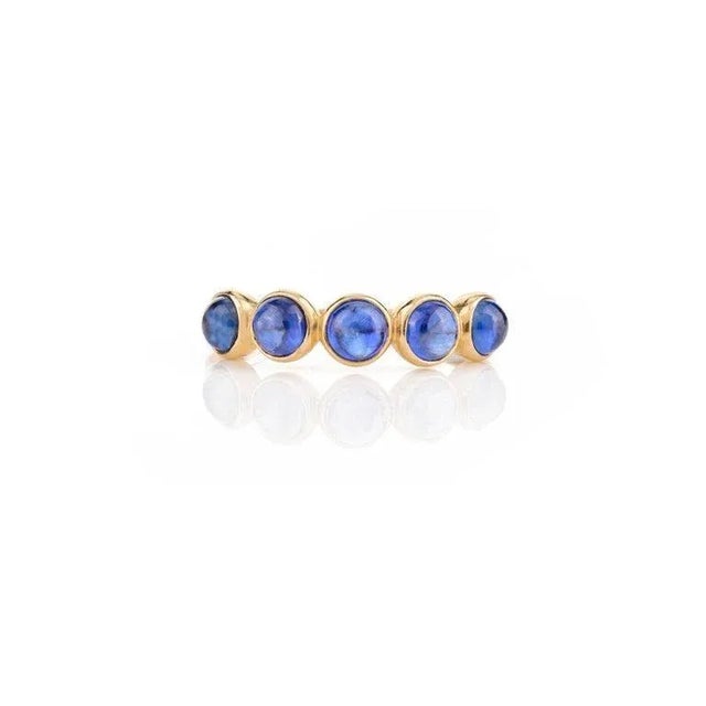 This is part of Chairish’s Fine Jewelry assortment. Blue Sapphire Bezel Set Band Stacking Ring in 14K Gold symbolizes the...