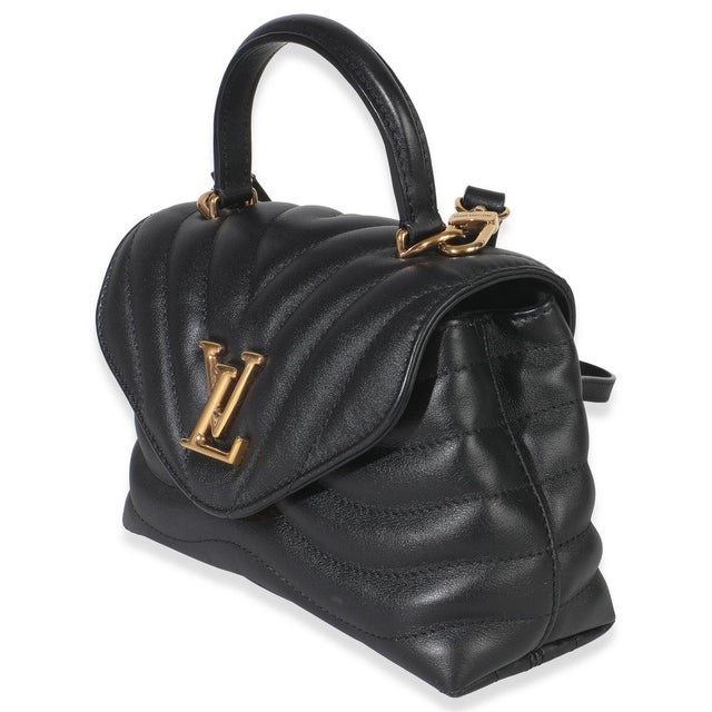 Make waves in the style department with the New Wave bag from Louis Vuitton. A chunky logo adorns the front, while curved...