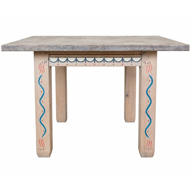 A distinctive Southwestern dining set by Ernest Thompson featuring a substantial solid-wood dining table accompanied by...