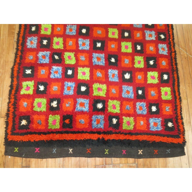 Bright colors highlight this mid-20th century intage Turkish Tulu rug. 4' x 4'11''