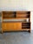 This impressive two-piece hutch features sliding lower doors and an upper display section with shelves and built-in...