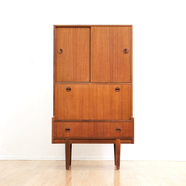 This fabulous mid century bar cabinet was manufactured by Turnidge of London during the 1960s. Produced in teak, this...