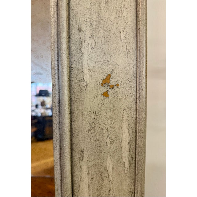 Exquisite French style trumeau mirror, beautifully crafted with neoclassical details and a timeworn patina. The lustrous...