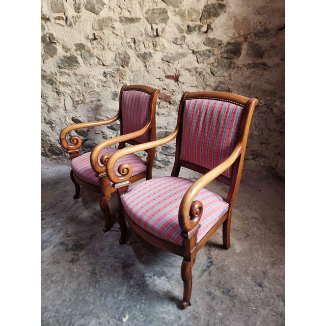 This elegant pair of French armchairs was produced in the 1950s and crafted from solid walnut wood. The chairs are...