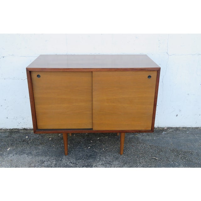 This wonderful TV cabinet is made out of wood, walnut, and veneer. The Server has a Mid Century style and design, tapered...