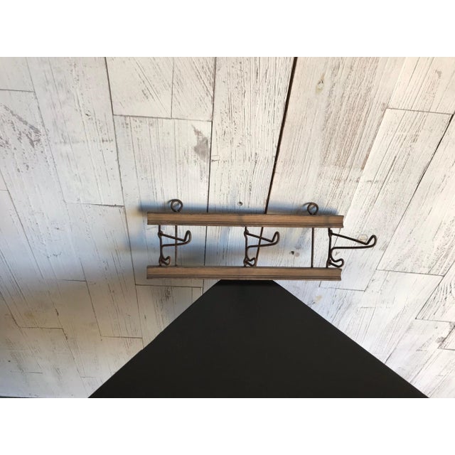 Wall-mounted hanger: circa 1900. With wooden base and folding iron pegs. Original, cleaned condition.