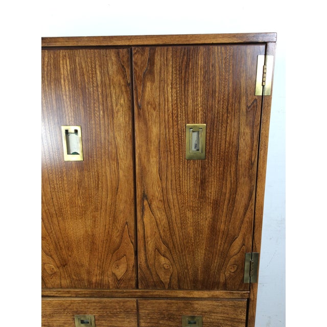 This mid century campaign style armoire by Stanley features hardwood construction, beautiful oak veneer with original...