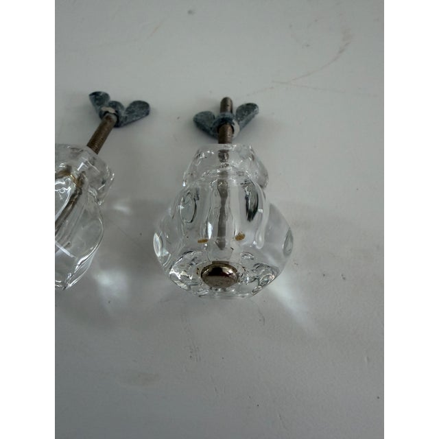 Pair of vintage clear pressed-glass cabinet or drawer knobs with faceted floral-form faces and original threaded mounting...