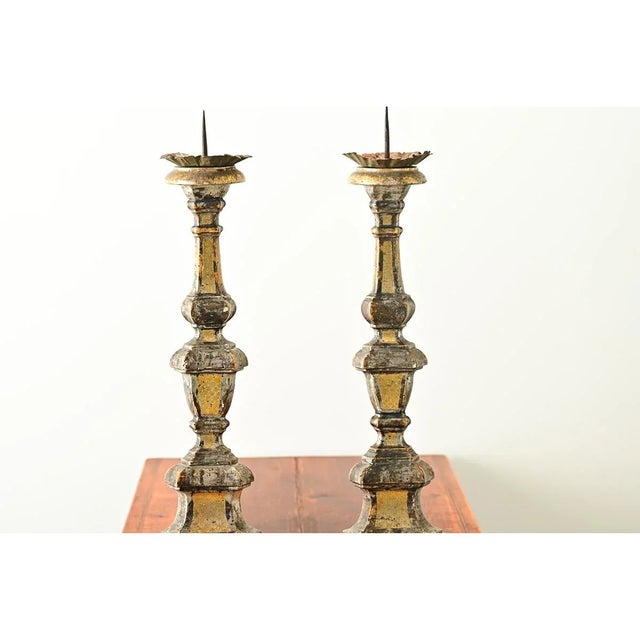 A glorious pair of Italian giltwood altar candlesticks from the 1500’s; equally impressive is that this hand-carved pair...