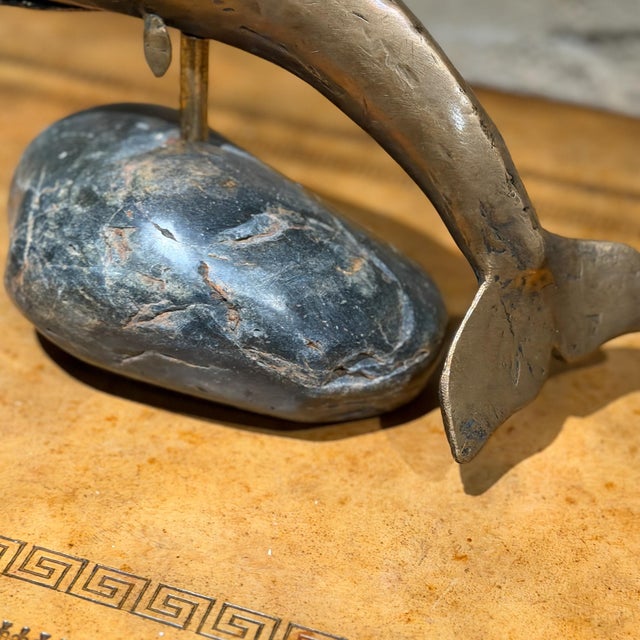 For your consideration, a decorative sculpture of a whale, made from bronze, and mounted on a natural stone in dark grey...