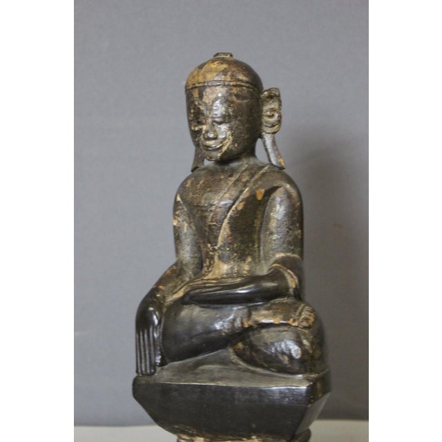 Black lacquered wooden Buddha with traces of gilding, depicted seated in the lotus position, origin Burma or Laos, 19th...
