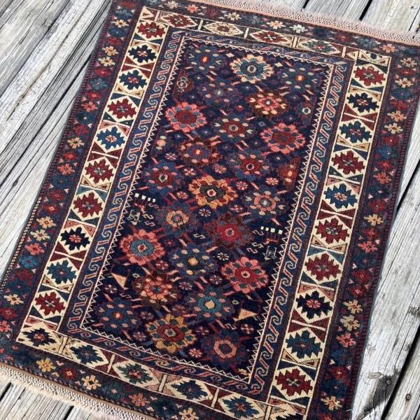 A striking antique Kazak rug, hand-knotted in the Caucasus approximately 120 years ago, embodying the bold geometry and...