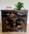 A beautifully restored vintage chinoiserie cabinet, likely dating to the late 20th century, featuring a classic black...