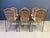 Vintage wrought iron and wicker bistro/dining chairs designed by Frederick Weinberg. Elegant dark grey wrought frame with...