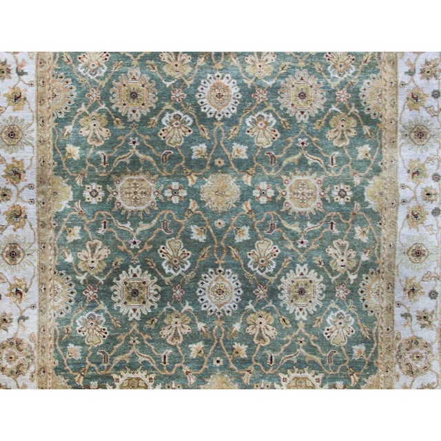 A gorgeous late 20th century Indian Tabriz style rug with an all-over floral trellis pattern with large-scale flowers and...