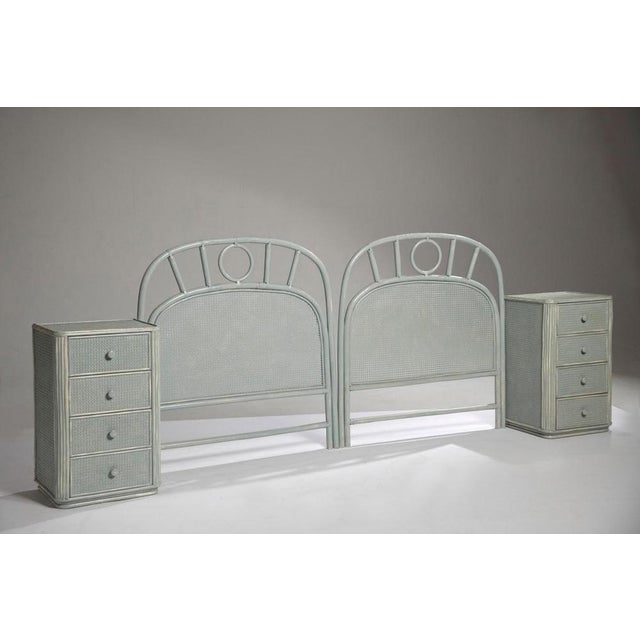 1970s distressed bamboo and rattan set, comprising two headboards and two matching bedside tables. The headboards feature...