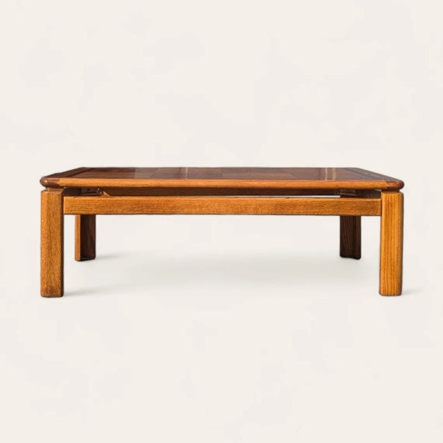 A generously scaled oak coffee table with a distinctive checkered parquet top that turns the natural grain into a graphic...