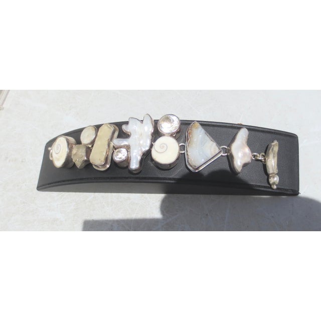 Fresh water Pearl, Crystal, Shell, and Geode free-formed links set in silver. Sterling mark to the back and The Dreamer....