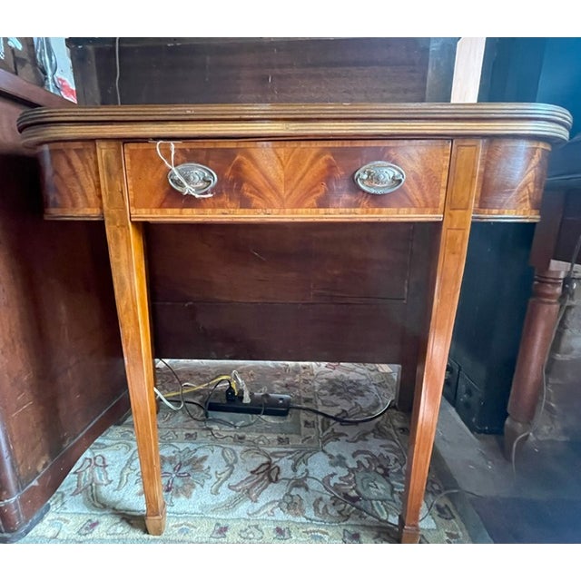 Swivel folding top accent card table. Mahogany veneer with attractive striped grain top. Round corners and waterfall...