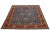 This Serapi-style hand-knotted wool rug features a navy blue color field. The piece showcases a red-designed frame and a...