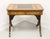 A Regency style game table by Drexel Heritage. Mahogany with a lighter finish, a banded embossed & tooled leather top,...