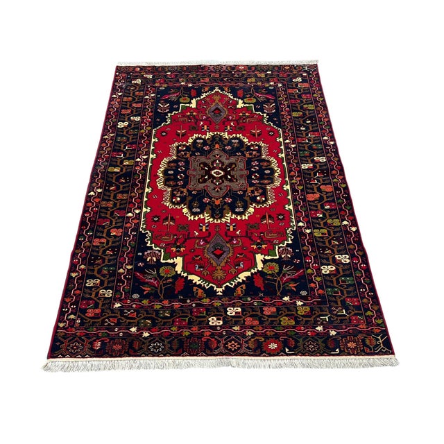Afghan Balouch rug, hand knotted in Afghanistan from 100% wool. Measuring 4’4” x 6’1”, this striking tribal rug features a...
