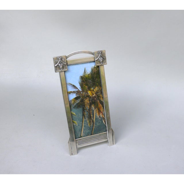 An elegant picture frame, made in Austria during the early Art Nouveau period, from silver-plated brass. The frame is...