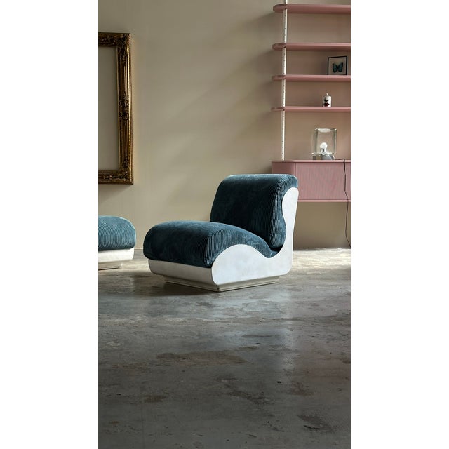 Set of two seventies armchairs, Italian manufacturing. The armchairs have a white fiberglass structure with a blue ribbed...