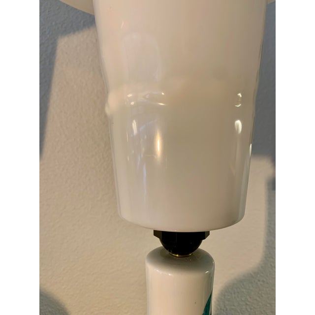 The lamps are original pieces from the period. One of the plastic shades has a small area where the plastic melted...