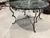 This large, 39”, French coffee table features a wrought iron base and a stunning green and black marble top. In excellent...