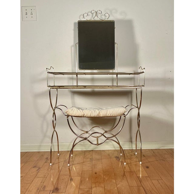 Vintage Mid Century makeup vanity table and matching vanity stool bench with cushion. Set featuring 2-tired shelving,...