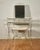 Vintage Mid Century makeup vanity table and matching vanity stool bench with cushion. Set featuring 2-tired shelving,...