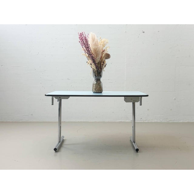 This original kelko folding table impresses with its ingenious folding mechanism and clean, functional design. With just a...