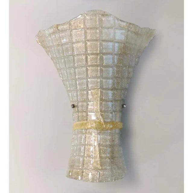 Vintage Italian wall light with a clear Murano glass shade infused with gold flecks, hand blown with granular texture...