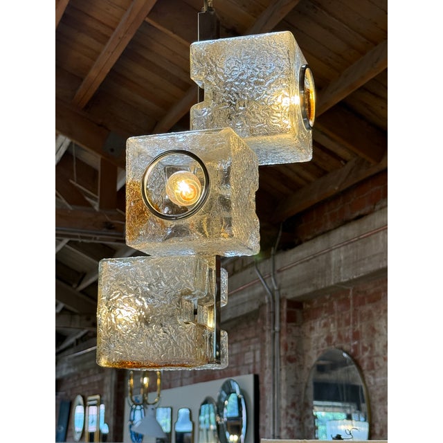 A striking Mid-Century Modern pendant light designed by Toni Zuccheri for VeArt Murano in the 1970s. This sculptural...
